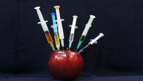 Apple with syringes for dispatches