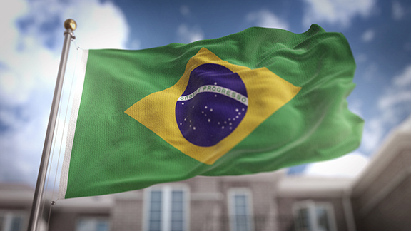 Brazil Flag 3D Rendering on Blue Sky Building Background 