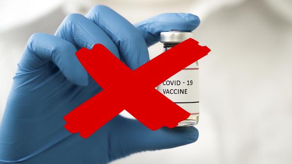 doctor holding coronavirus vaccine with red cross